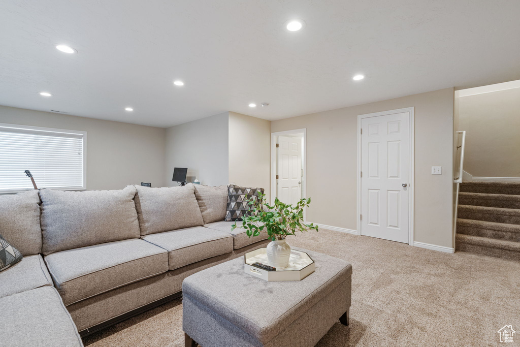Living area featuring carpet floors, recessed lighting, stairway, and baseboards
