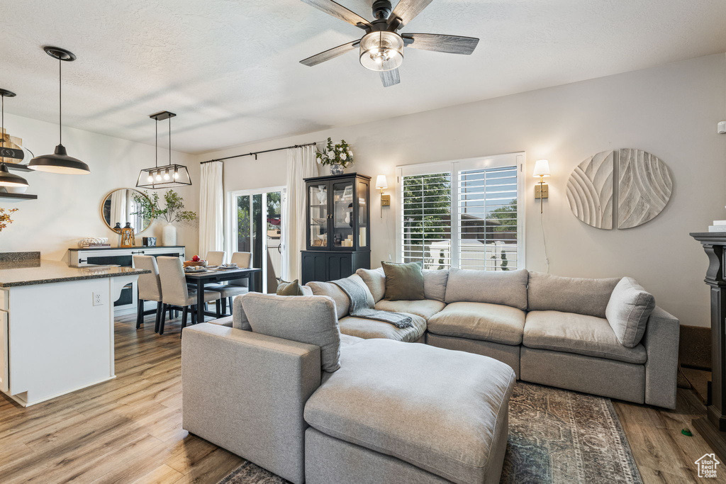 Living room featuring light wood-style flooring and a ceiling fan