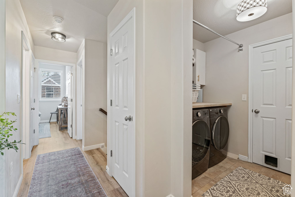 Laundry room featuring separate washer and dryer and baseboards