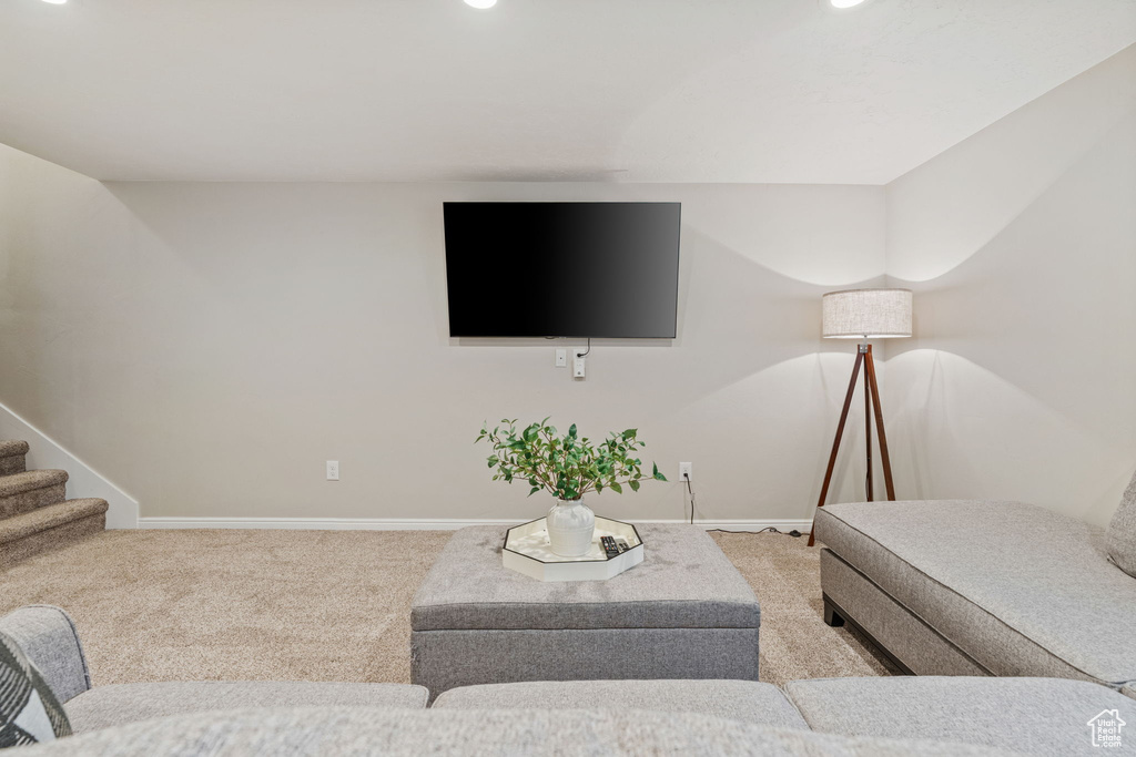 Living room with carpet floors, baseboards, recessed lighting, and stairway