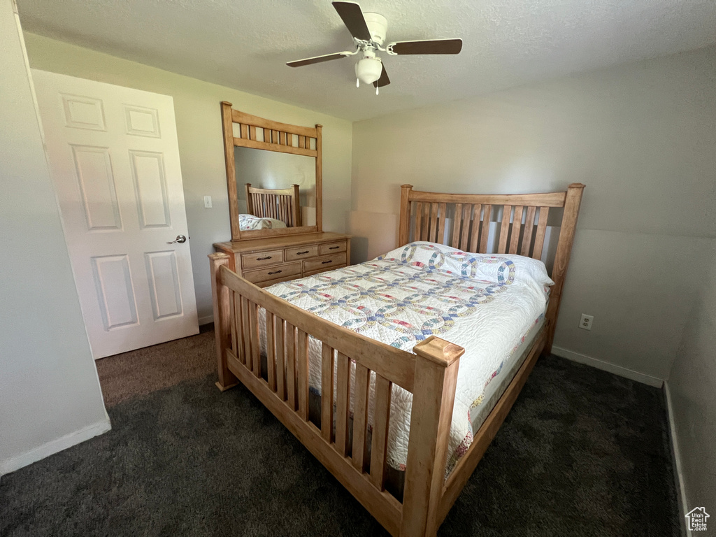 Carpeted bedroom with baseboards and a ceiling fan