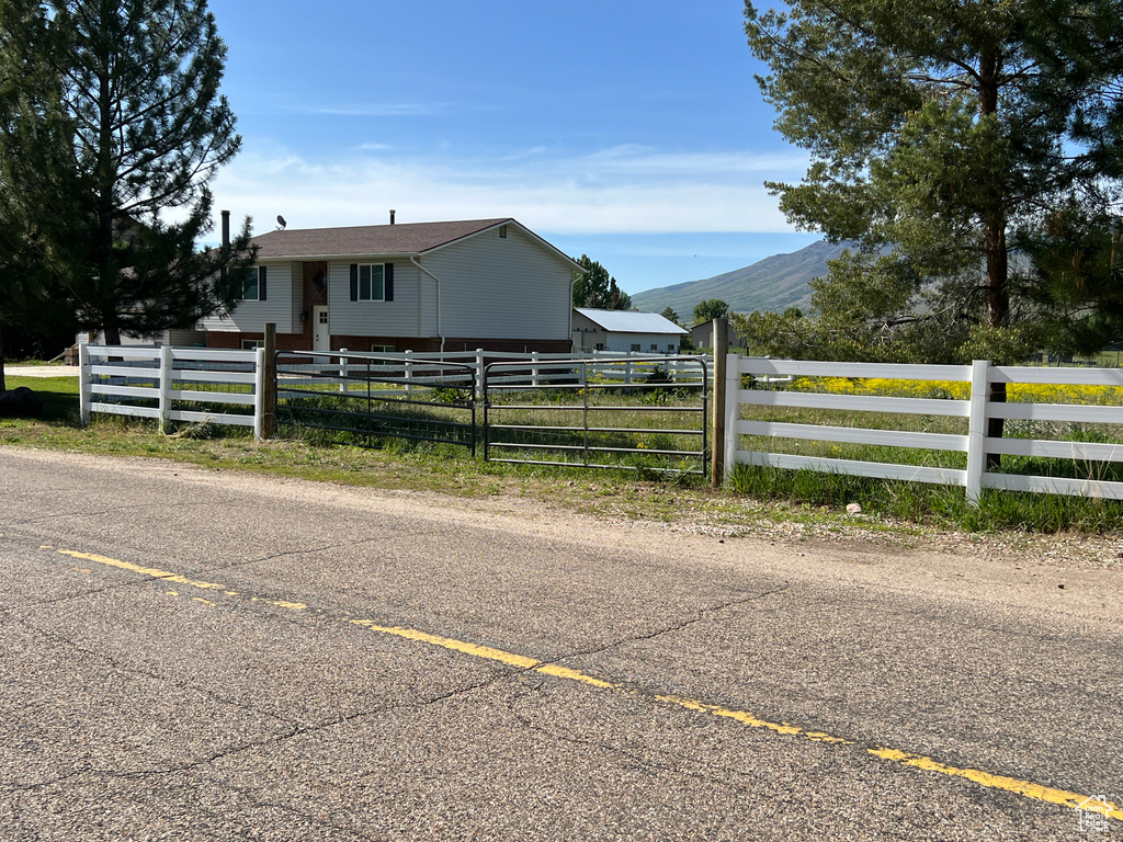 View of front of house featuring a fenced front yard and a mountain view