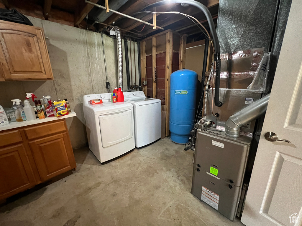 Laundry room with independent washer and dryer and cabinet space
