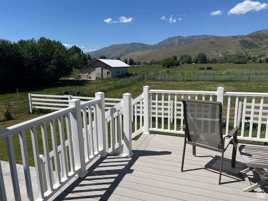 Deck featuring a mountain view and a view of rural / pastoral area