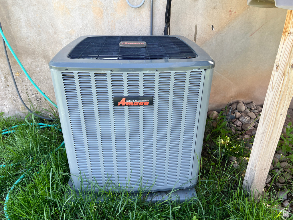 Exterior view of cooling unit and stucco siding