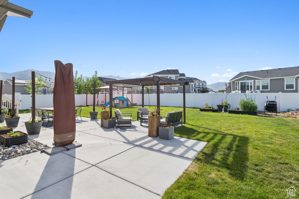 View of patio with a playground, a mountain view, and a residential view
