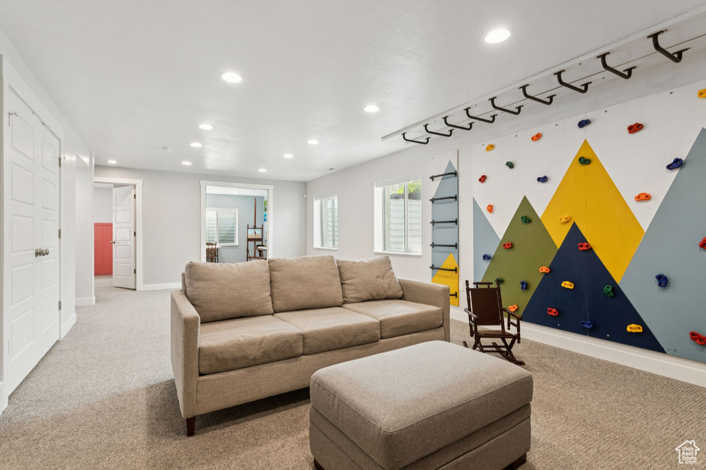 Living area featuring recessed lighting, light colored carpet, and baseboards