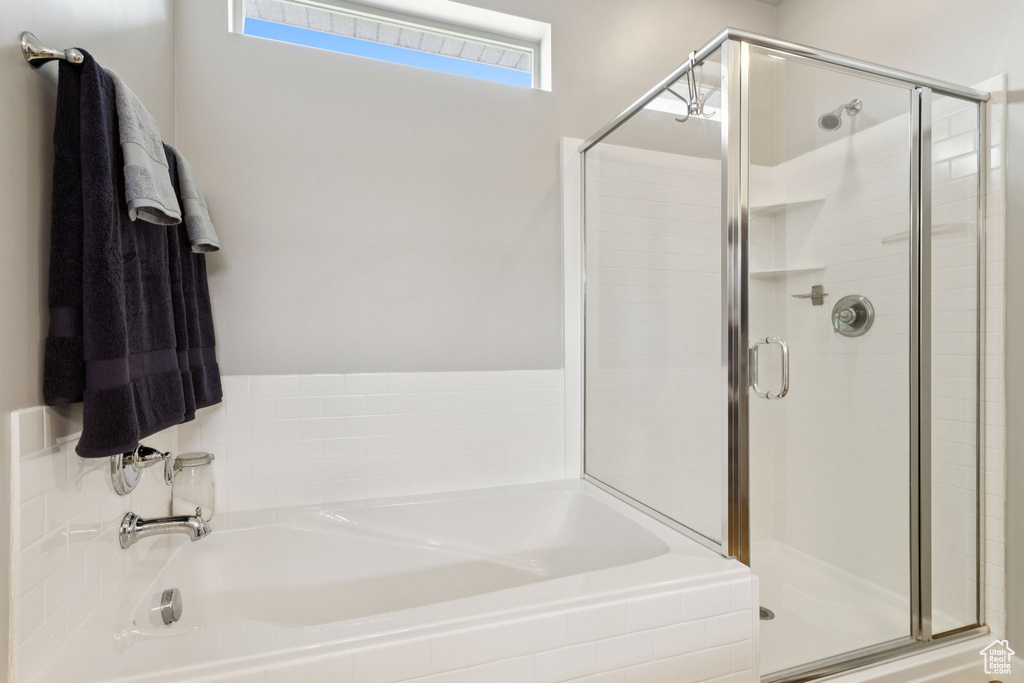 Full bath featuring a bath and a shower stall