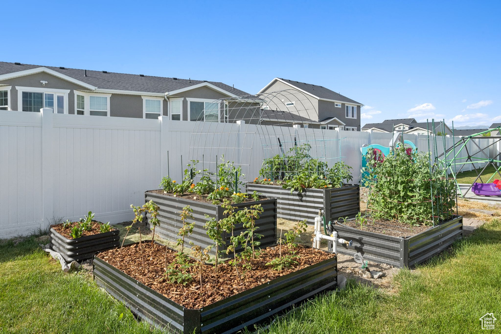 View of yard featuring a garden and a residential view