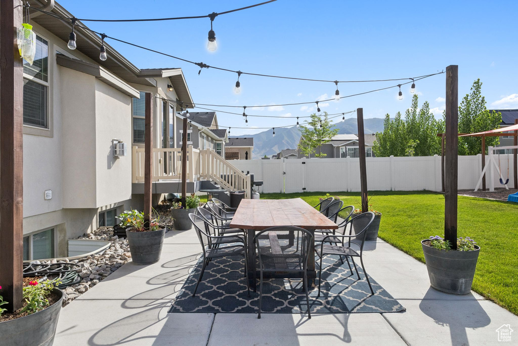 View of patio / terrace featuring outdoor dining space and a mountain view