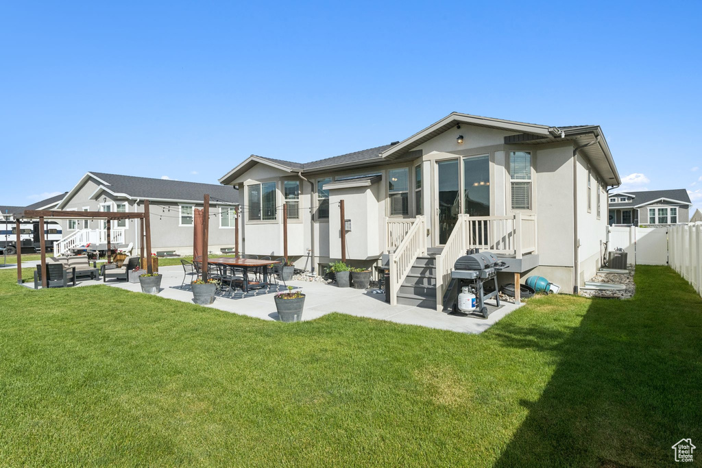 Rear view of house featuring a patio and stucco siding