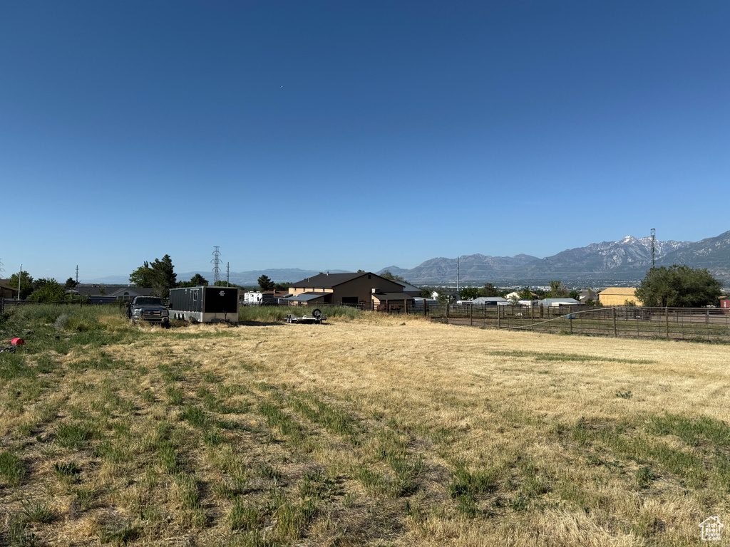 View of yard with a mountain view and a view of rural / pastoral area