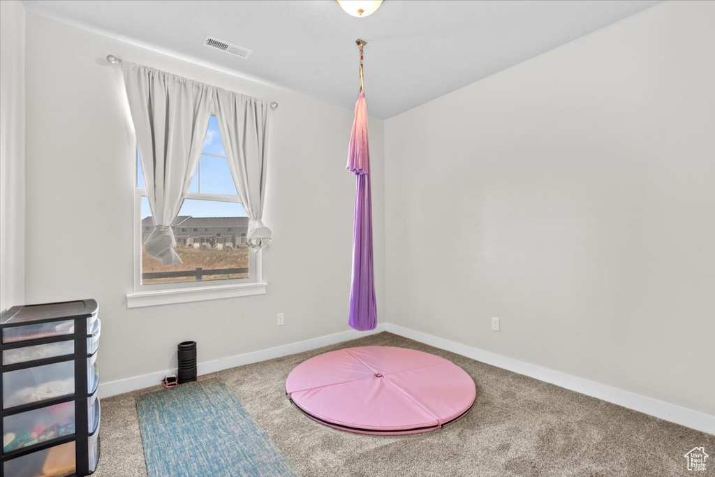 Game room with carpet flooring and baseboards