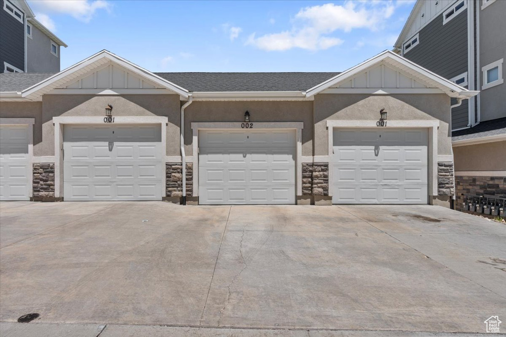 Garage featuring concrete driveway