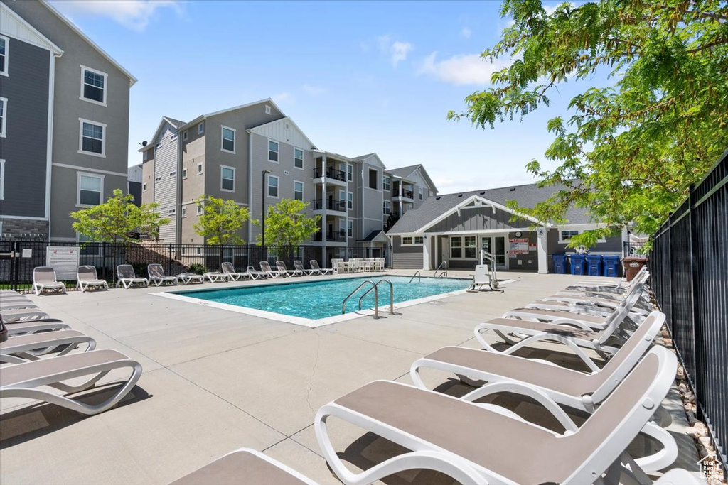 Community pool with a patio