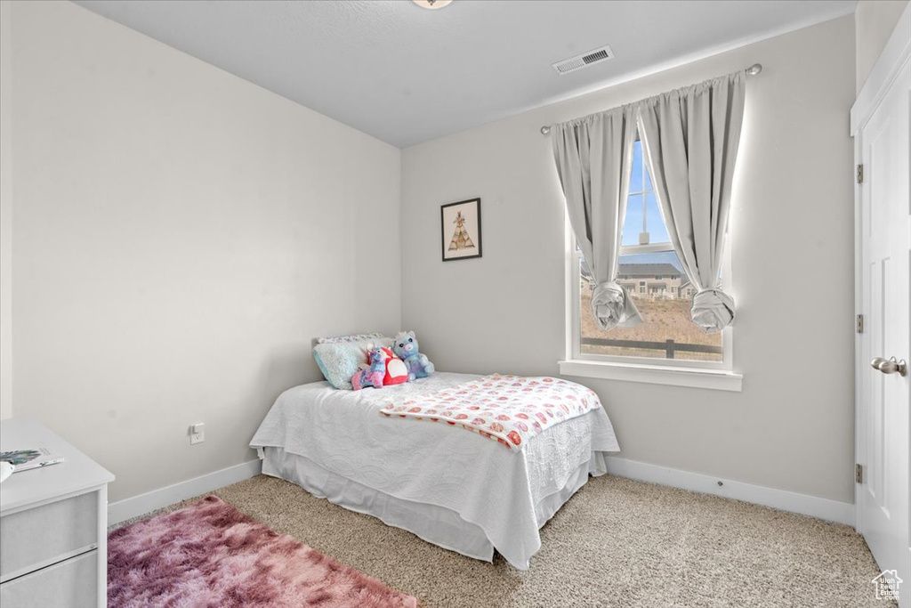Bedroom with baseboards and carpet flooring