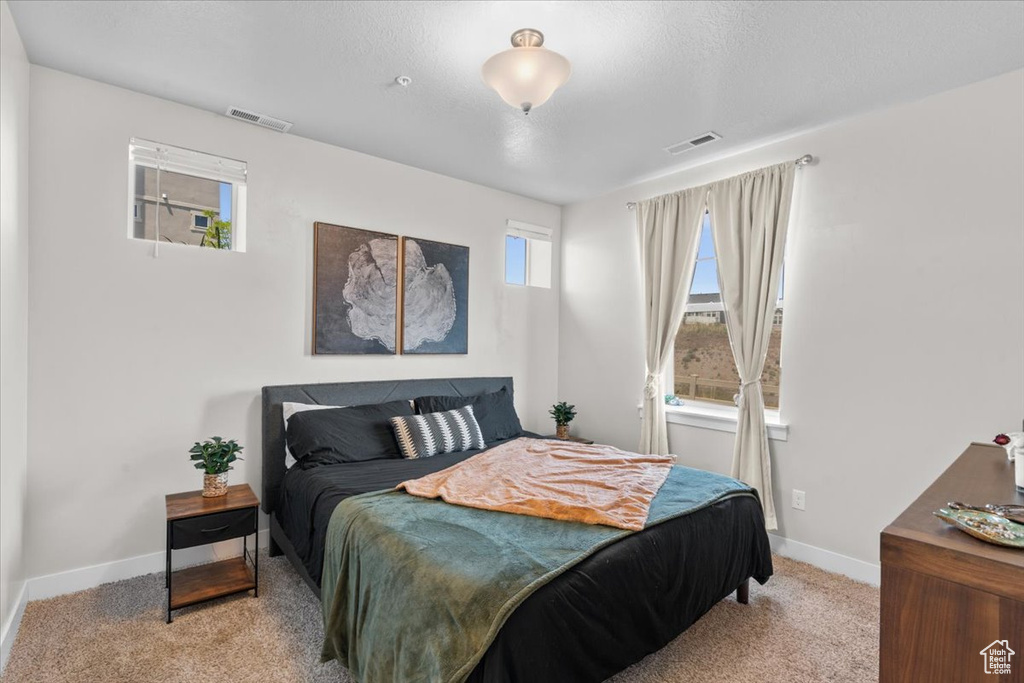 Carpeted bedroom featuring baseboards