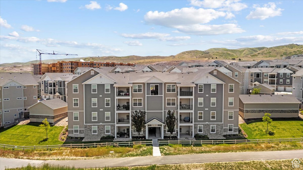 View of building exterior with a residential view and a mountain view
