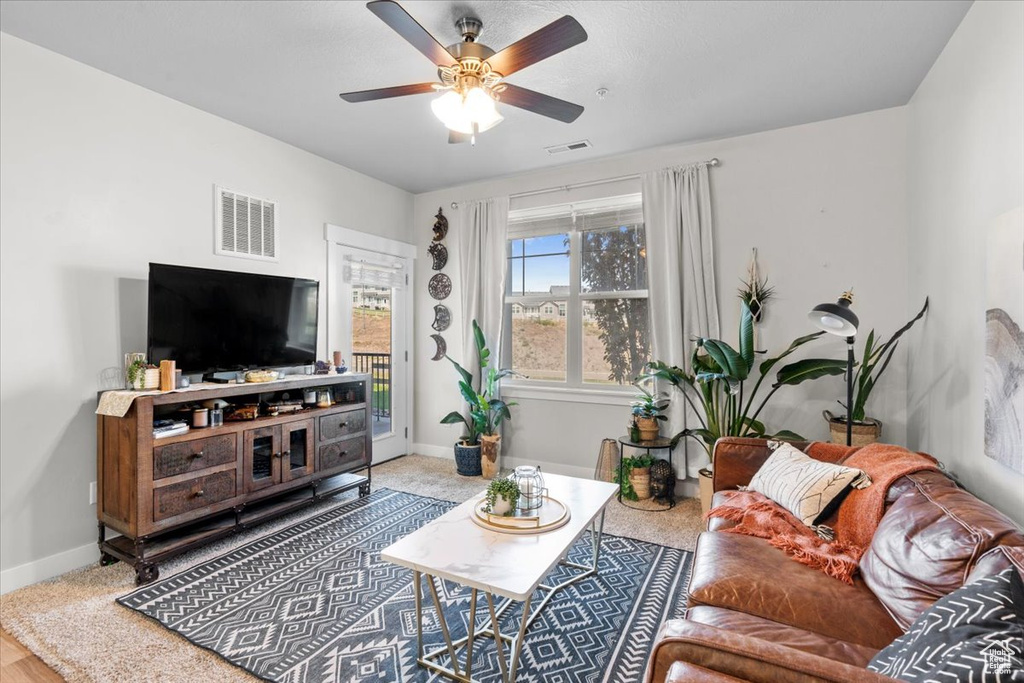 Living area with baseboards and ceiling fan