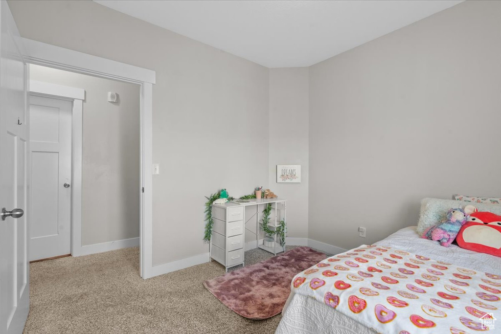 Carpeted bedroom featuring baseboards