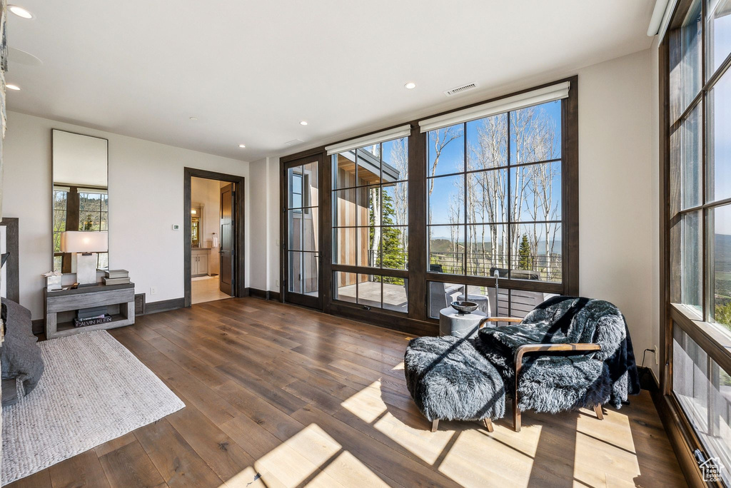 Living area featuring dark wood finished floors, baseboards, and recessed lighting