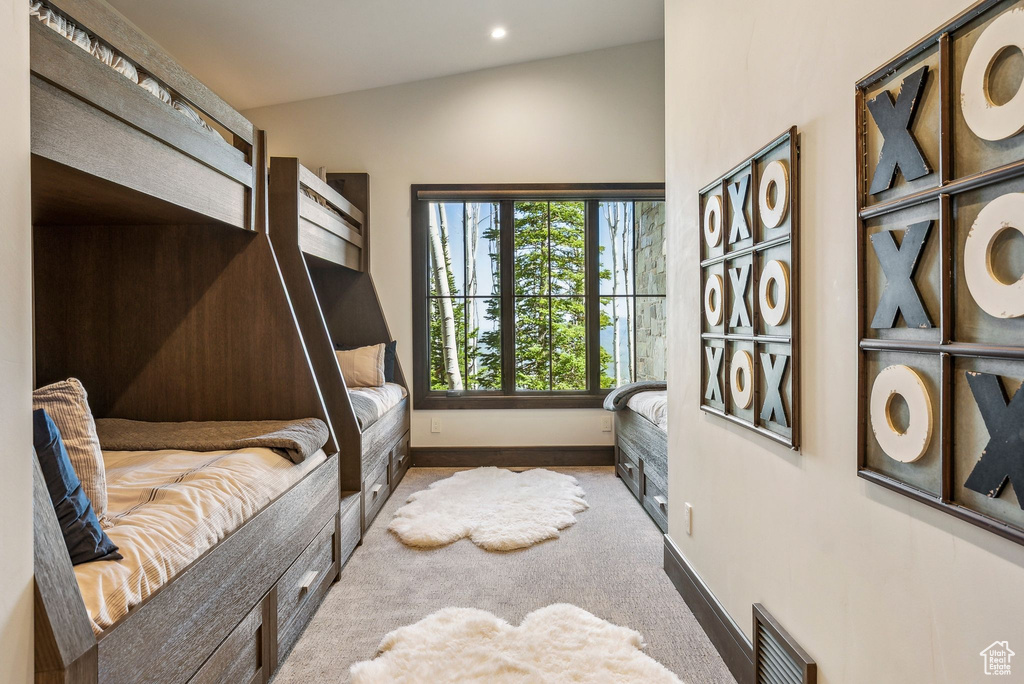 Carpeted bedroom with baseboards and recessed lighting