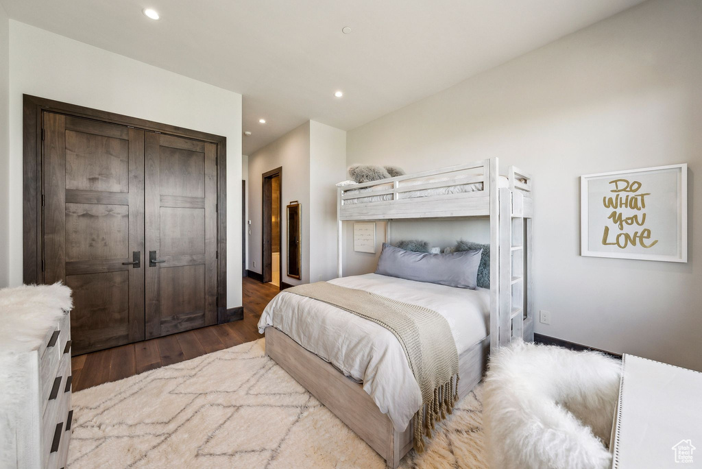 Bedroom featuring recessed lighting, wood finished floors, and a closet