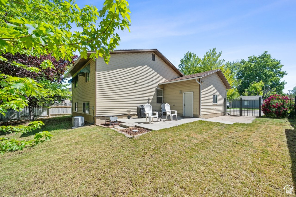 Rear view of property with a patio and central AC unit