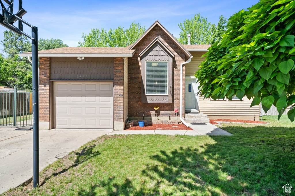 View of front of house with a garage, brick siding, driveway, and entry steps