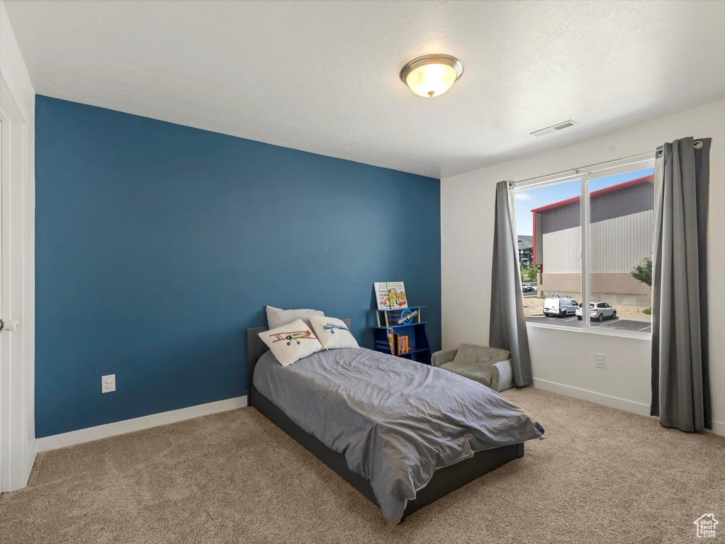 Carpeted bedroom featuring baseboards