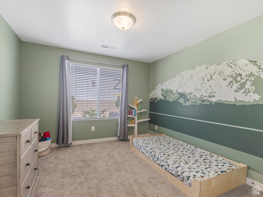 Bedroom featuring carpet and baseboards