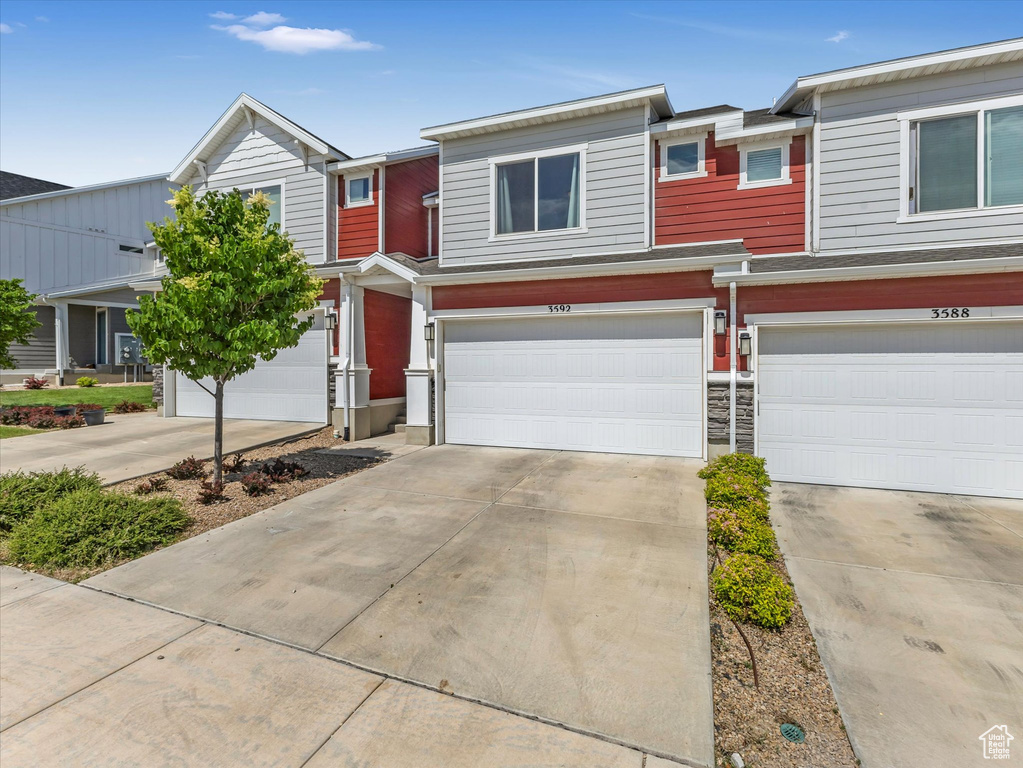 Multi unit property with concrete driveway and a garage