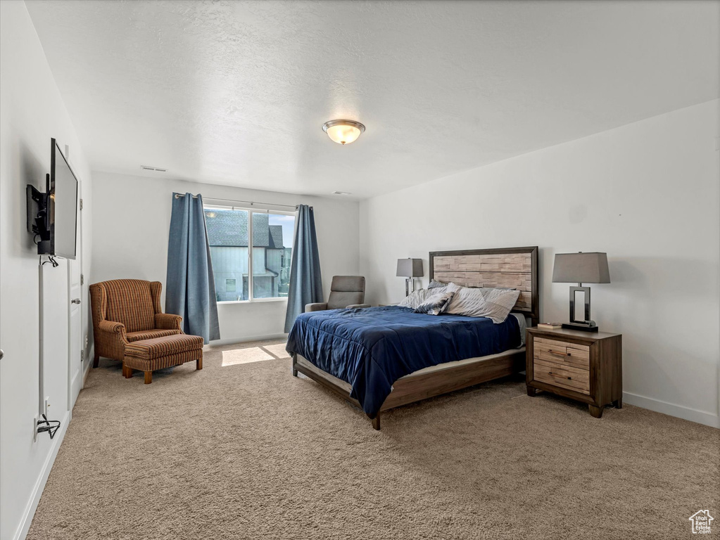 Carpeted bedroom with baseboards