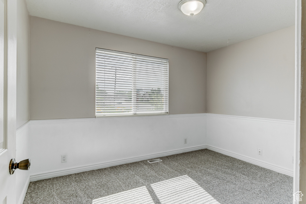 Unfurnished room with carpet and baseboards