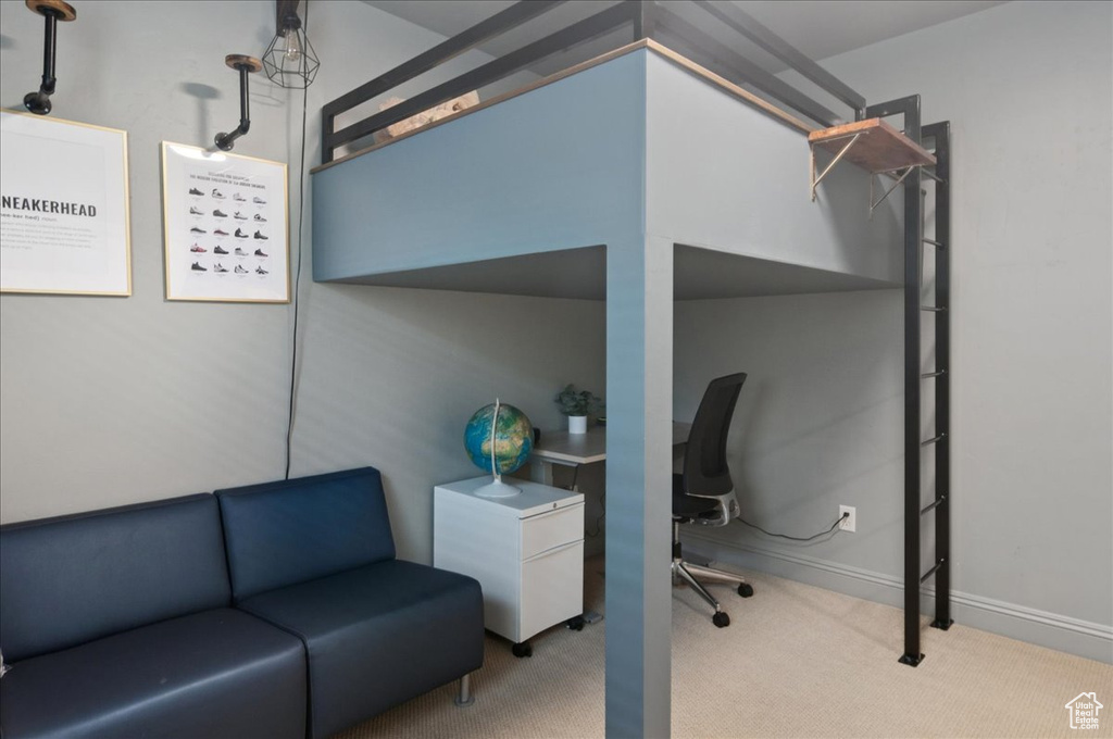 Bedroom with carpet floors, baseboards, and an office area