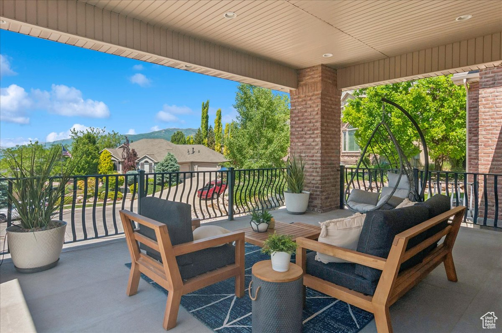 View of patio with a balcony and a mountain view