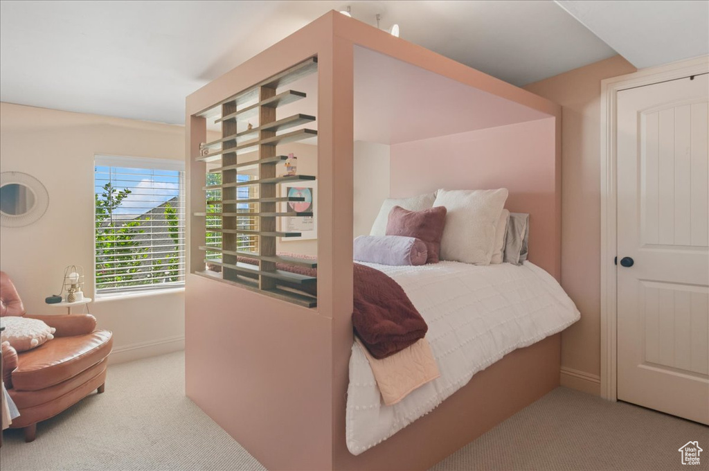 Bedroom with carpet flooring and baseboards