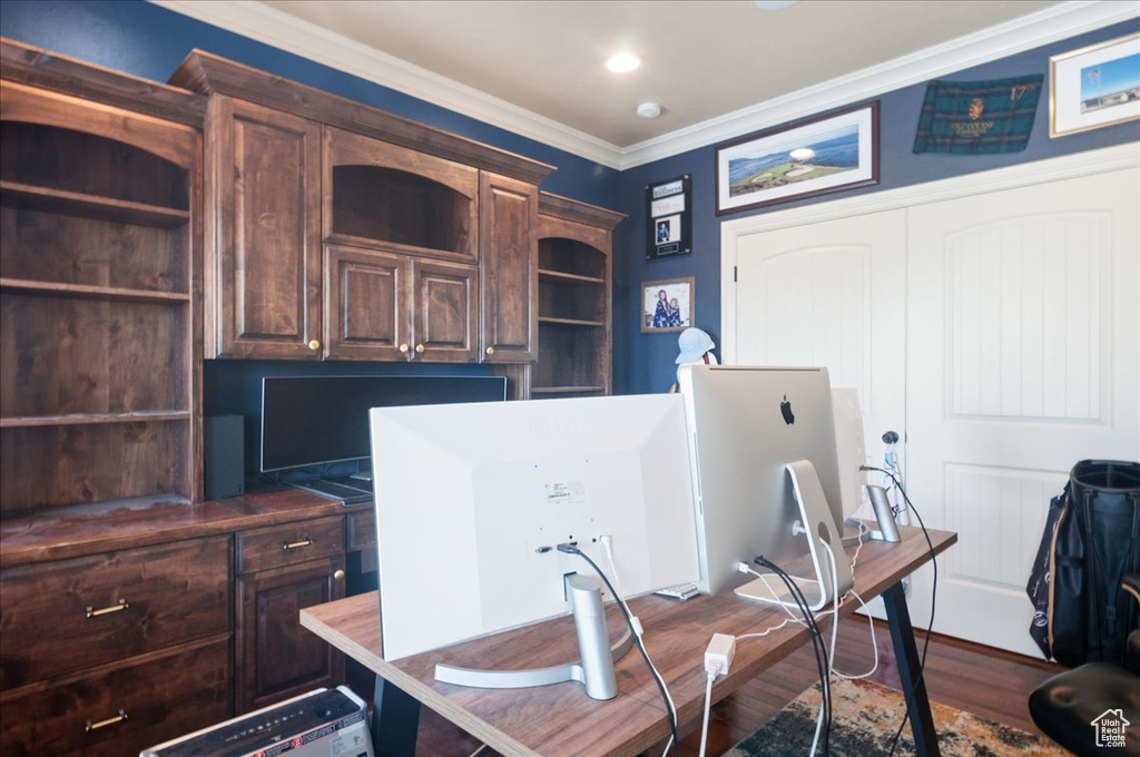 Office space featuring ornamental molding and dark wood-style flooring