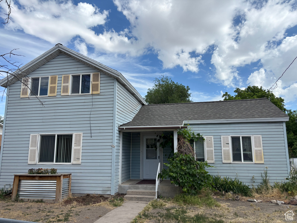 View of front of home with a shingled roof