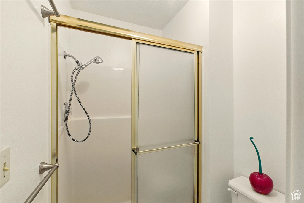 Full bath featuring an enclosed shower and toilet