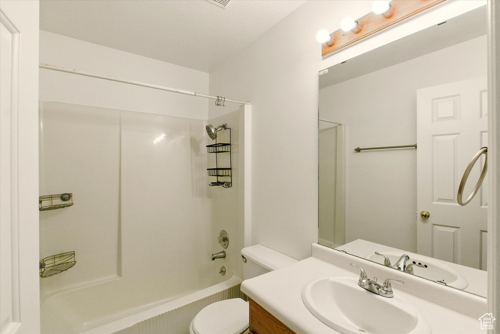 Full bath with toilet, vanity, and shower / bath combination
