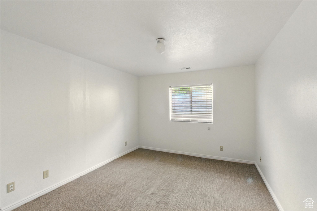 Unfurnished room with carpet flooring and baseboards