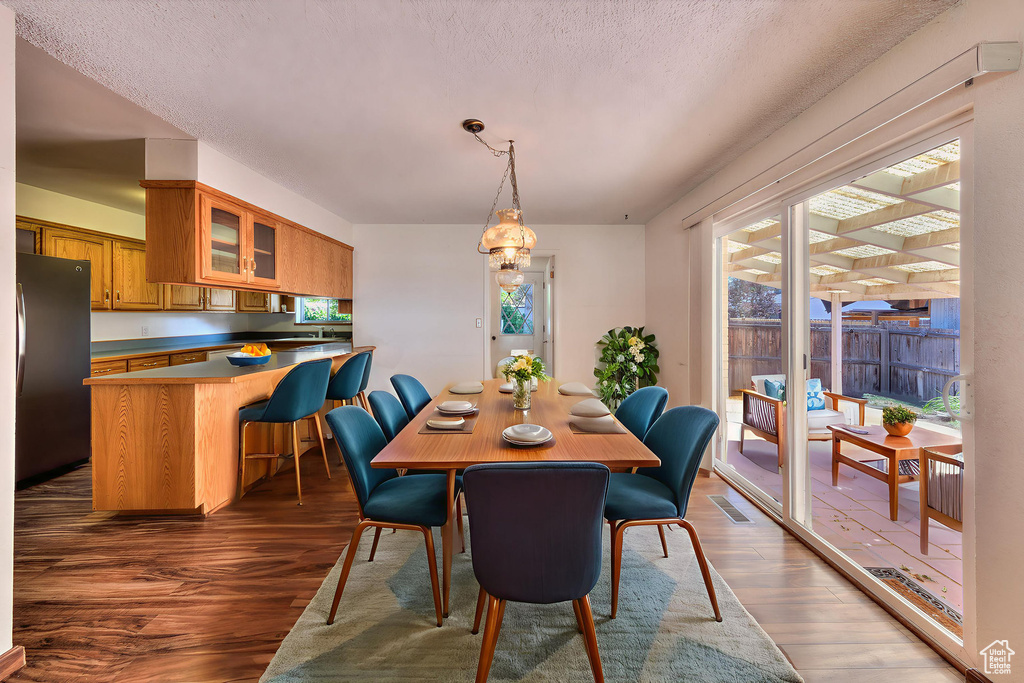 Dining space featuring wood finished floors and a textured ceiling