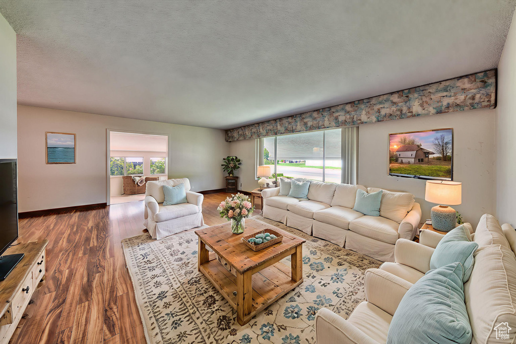 Living area with wood finished floors and baseboards