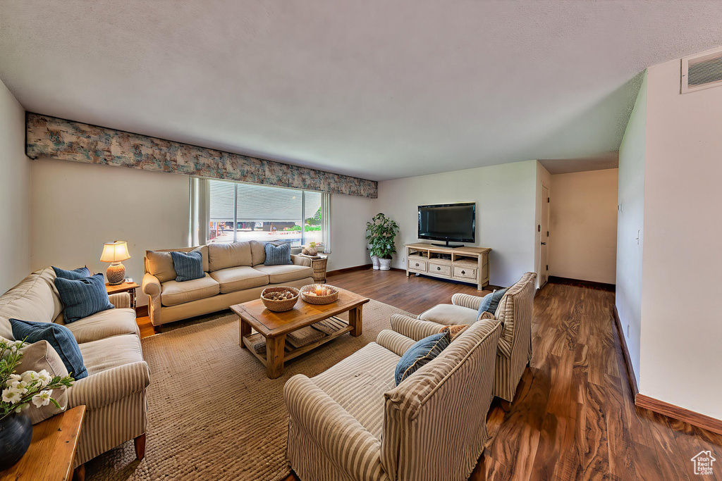Living room featuring baseboards and wood finished floors