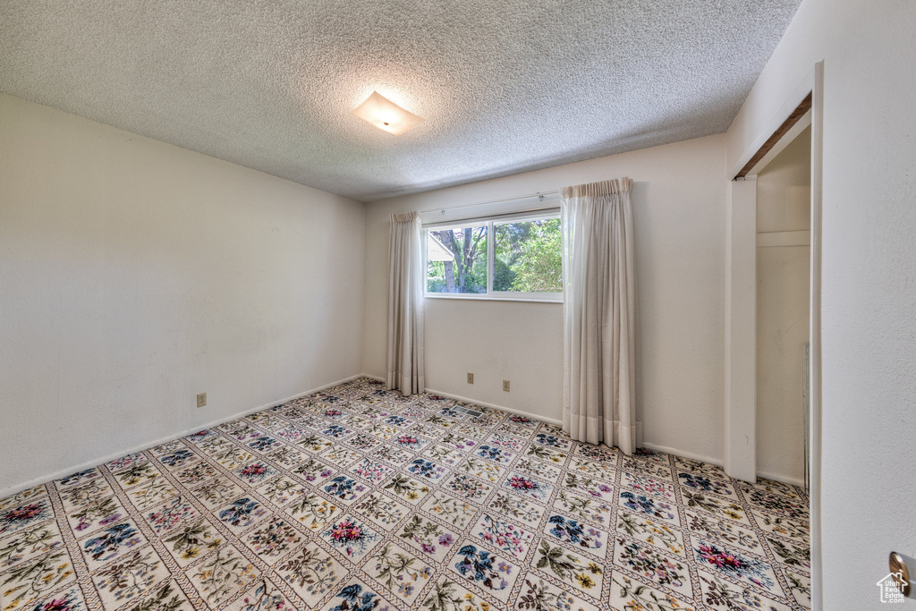 Unfurnished bedroom featuring a textured ceiling