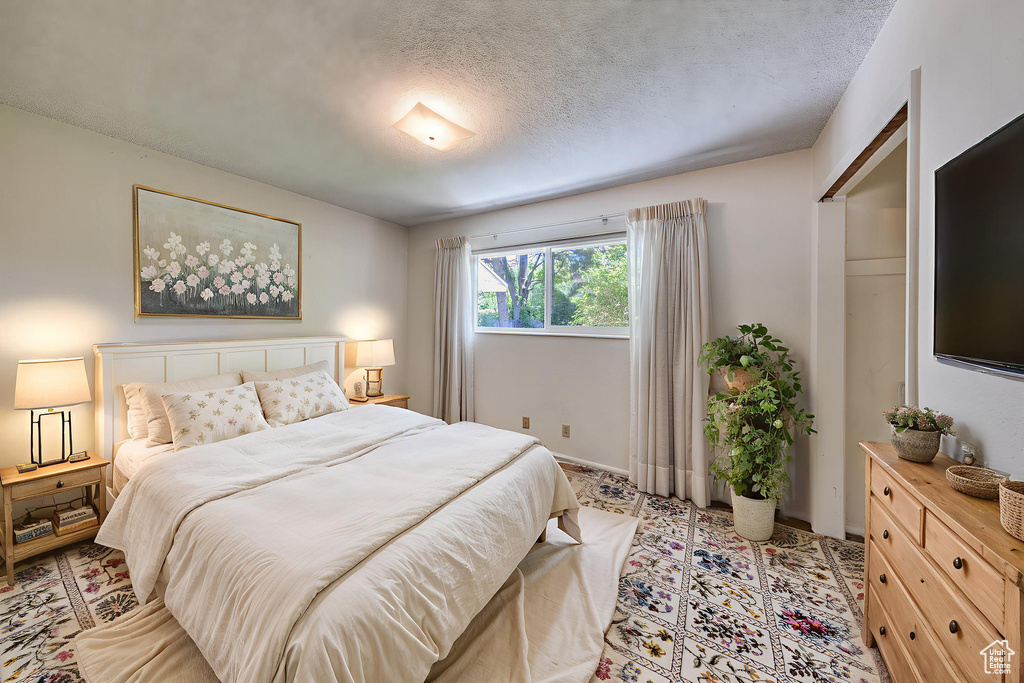 Bedroom with a textured ceiling