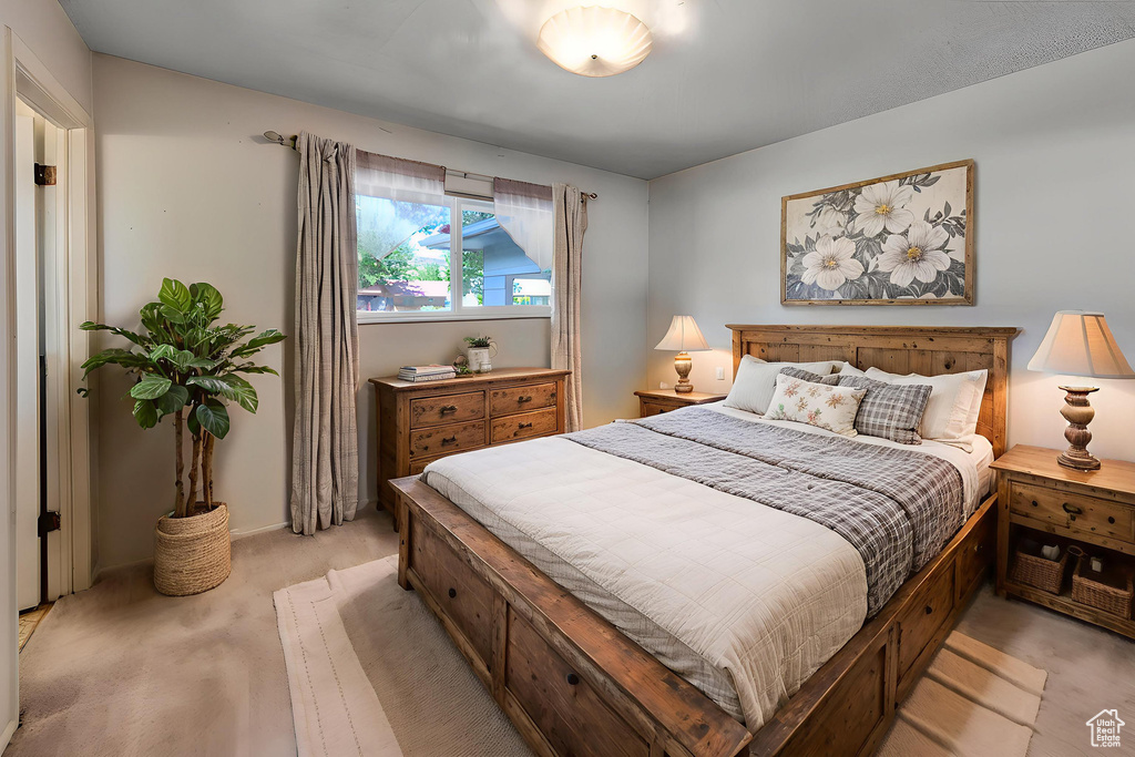 Bedroom featuring light carpet