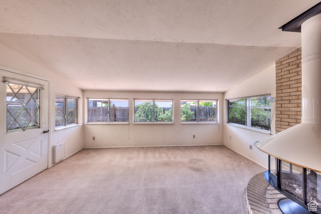 Unfurnished sunroom with vaulted ceiling