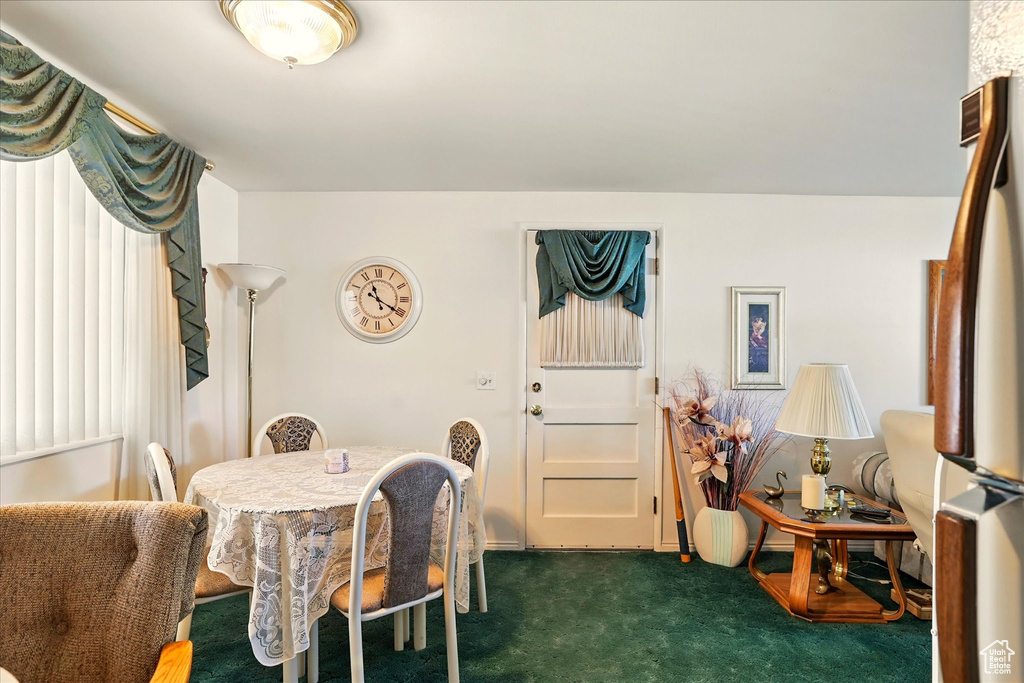 Dining area with dark colored carpet